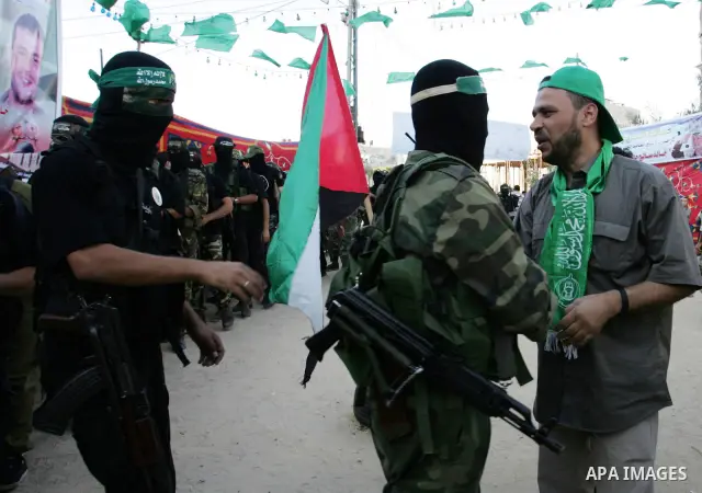 Hamas militants visit Khaled AL Moghiar a freed Palestinian prisoner in Rafah in southern Gaza Strip October 19, 2011. Palestinians freed by Israel in a trade for soldier Gilad Shalit took their morning exercise on Wedne...
