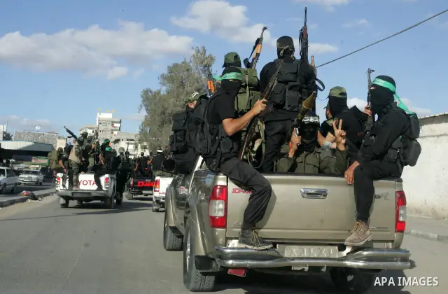 Hamas militants pray before going to pay their respects to freed Palestinian prisoners in Rafah, southern Gaza Strip, Wednesday, Oct. 19, 2011. Tens of thousands of flag-waving Palestinians celebrated the homecoming of h...