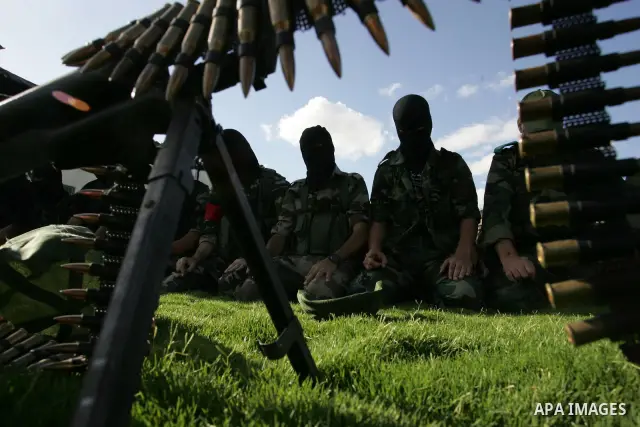 Hamas militants pray before going to pay their respects to freed Palestinian prisoners in Rafah, southern Gaza Strip, Wednesday, Oct. 19, 2011. Tens of thousands of flag-waving Palestinians celebrated the homecoming of h...
