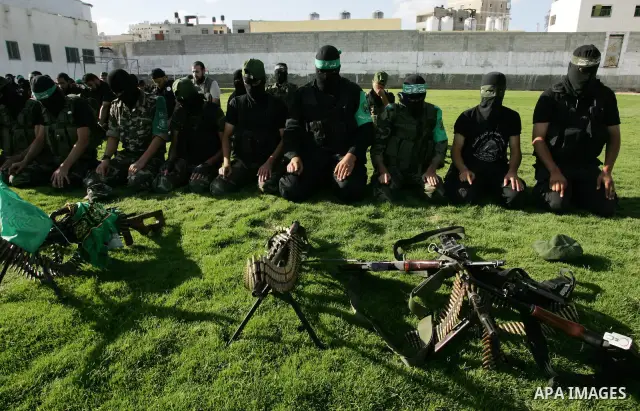 Hamas militants pray before going to pay their respects to freed Palestinian prisoners in Rafah, southern Gaza Strip, Wednesday, Oct. 19, 2011. Tens of thousands of flag-waving Palestinians celebrated the homecoming of h...