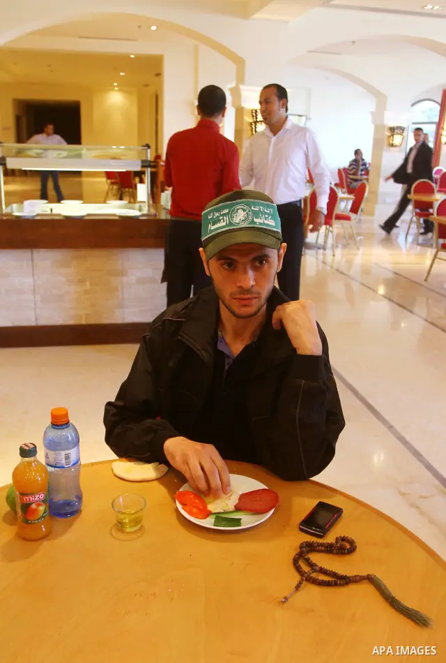 Freed Palestinian prisoners sit in the cafe of Al-Mashtal hotel, where they staying, in the Gaza Strip October 20, 2011. Israeli soldier Gilad Shalit and hundreds of Palestinians crossed Israel's borders in opposite dire...