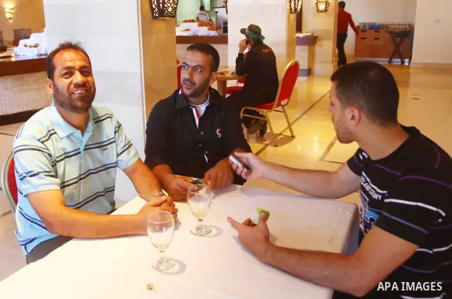 Freed Palestinian prisoners sit in the cafe of Al-Mashtal hotel, where they staying, in the Gaza Strip October 20, 2011. Israeli soldier Gilad Shalit and hundreds of Palestinians crossed Israel's borders in opposite dire...
