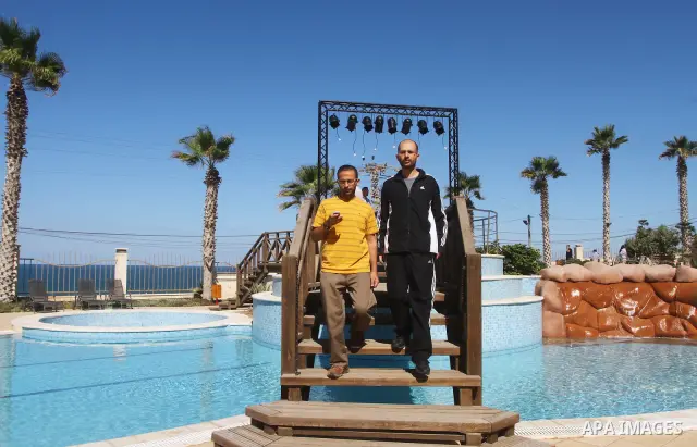 A freed Palestinian prisoner sits near a swimming pool at Al-Mashtal hotel, where he and other former prisoners are currently staying, in the Gaza Strip Oct. 20, 2011. Israeli soldier Gilad Shalit and hundreds of Palesti...