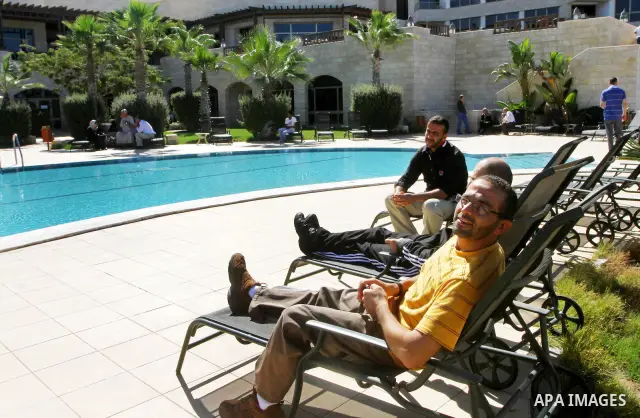 A freed Palestinian prisoner sits near a swimming pool at Al-Mashtal hotel, where he and other former prisoners are currently staying, in the Gaza Strip Oct. 20, 2011. Israeli soldier Gilad Shalit and hundreds of Palesti...