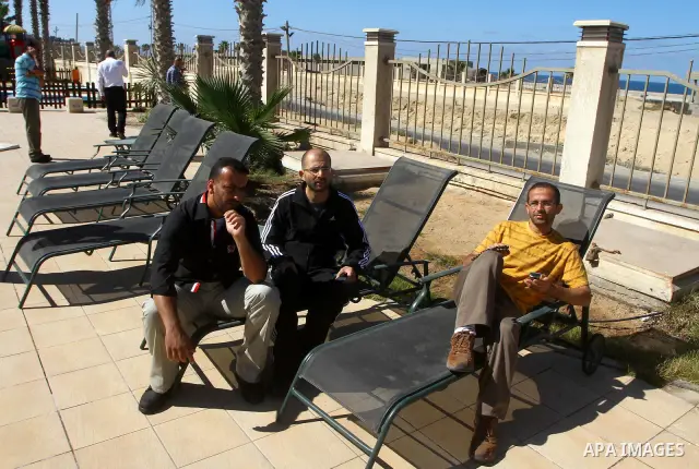 A freed Palestinian prisoner sits near a swimming pool at Al-Mashtal hotel, where he and other former prisoners are currently staying, in the Gaza Strip Oct. 20, 2011. Israeli soldier Gilad Shalit and hundreds of Palesti...