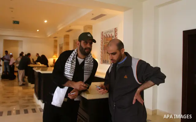 Freed Palestinian prisoners sit in the cafe of Al-Mashtal hotel, where they staying, in the Gaza Strip October 20, 2011. Israeli soldier Gilad Shalit and hundreds of Palestinians crossed Israel's borders in opposite dire...