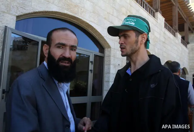 Freed Palestinian prisoners sit in the cafe of Al-Mashtal hotel, where they staying, in the Gaza Strip October 20, 2011. Israeli soldier Gilad Shalit and hundreds of Palestinians crossed Israel's borders in opposite dire...