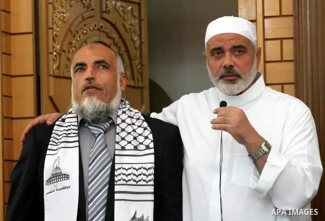Freed Palestinian prisoners attend Friday prayer with Hamas leader Ismail Haniya in Gaza City on October 21, 2011. Hamas rulers are enjoying a surge in popularity following the release earlier this week of 477 Palestinia...