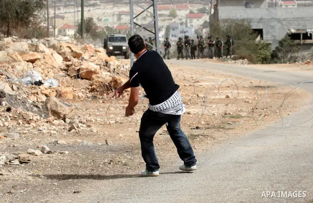 Palestinian demonstrators clash with Israeli border police officers as they demand access to their land near Kufr Qaddum, close to the northern West Bank Jewish settlement of Kdumim, Friday, Oct. 21, 2011. Photo by Wagdi...