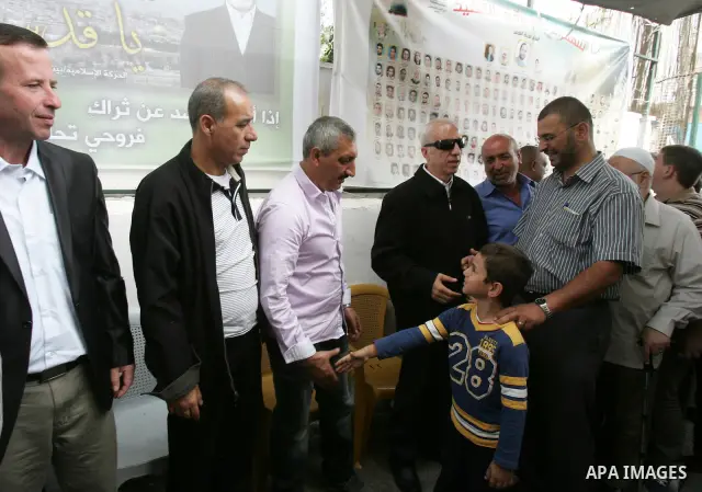 Freed Palestinian prisoners are greeted by others following their release from Israeli jails, at Red Cross headquarters in east Jerusalem on October 21, 2011. The Palestinian Hamas movement exchanged Gilad Shalit, the Is...