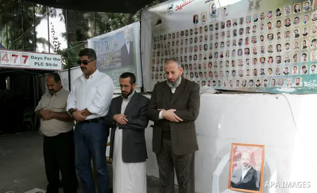 Freed Palestinian prisoners attend Friday prayers in a tent outside the Red Cross headquarters in east Jerusalem on October 21, 2011. The Palestinian Hamas movement exchanged Gilad Shalit, the Israeli soldier who spent m...