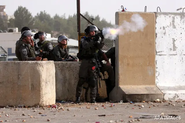 Israeli security forces fire teargas at Palestinians during clashes outside Israeli military prison Ofer near the West Bank city of Ramallah. Friday, Oct. 21, 2011. Photo by Issam Rimawi