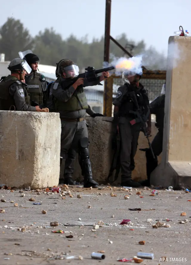 Israeli security forces fire teargas at Palestinians during clashes outside Israeli military prison Ofer near the West Bank city of Ramallah. Friday, Oct. 21, 2011. Photo by Issam Rimawi