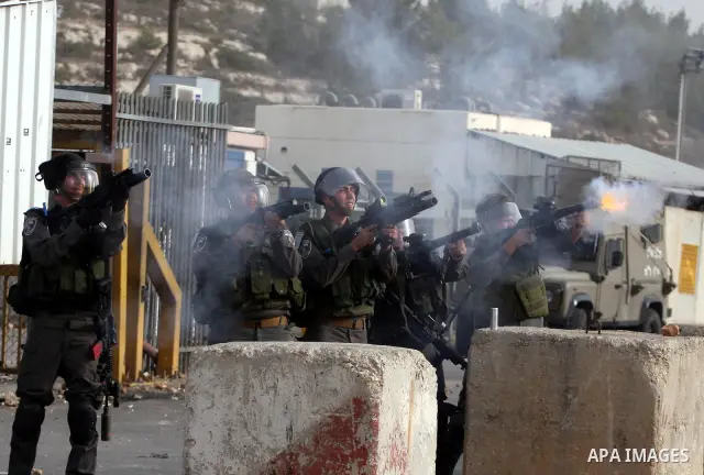 Israeli security forces fire teargas at Palestinians during clashes outside Israeli military prison Ofer near the West Bank city of Ramallah. Friday, Oct. 21, 2011. Photo by Issam Rimawi
