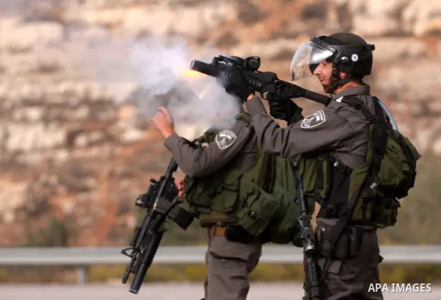 Israeli security forces fire teargas at Palestinians during clashes outside Israeli military prison Ofer near the West Bank city of Ramallah. Friday, Oct. 21, 2011. Photo by Issam Rimawi