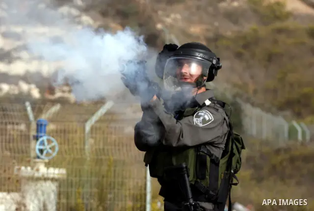 Israeli security forces fire teargas at Palestinians during clashes outside Israeli military prison Ofer near the West Bank city of Ramallah. Friday, Oct. 21, 2011. Photo by Issam Rimawi