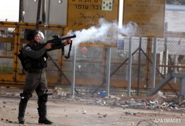 Israeli security forces fire teargas at Palestinians during clashes outside Israeli military prison Ofer near the West Bank city of Ramallah. Friday, Oct. 21, 2011. Photo by Issam Rimawi