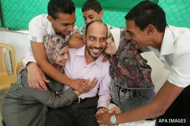 Freed Palestinian prisoner Rajab El-Tahan is greeted by relatives and friends after her release from an Israeli jail in the East Jerusalem neighbourhood on October 20, 2011. The Palestinian Hamas movement exchanged Gilad...