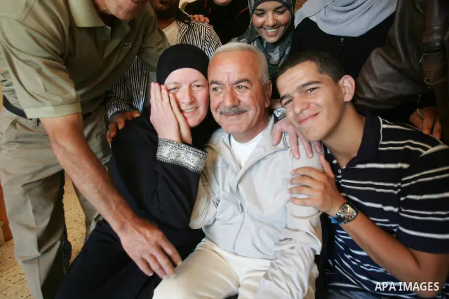 Freed Palestinian prisoner Issam Gandal is greeted by relatives and friends after her release from an Israeli jail in the East Jerusalem neighbourhood on October 20, 2011. The Palestinian Hamas movement exchanged Gilad S...
