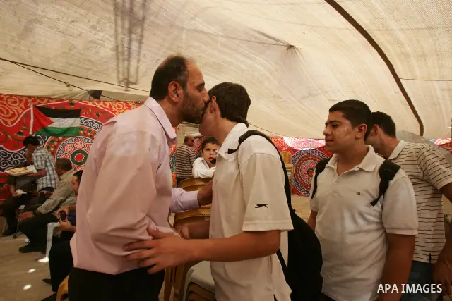Freed Palestinian prisoner Rajab El-Tahan is greeted by relatives and friends after her release from an Israeli jail in the East Jerusalem neighbourhood on October 20, 2011. The Palestinian Hamas movement exchanged Gilad...