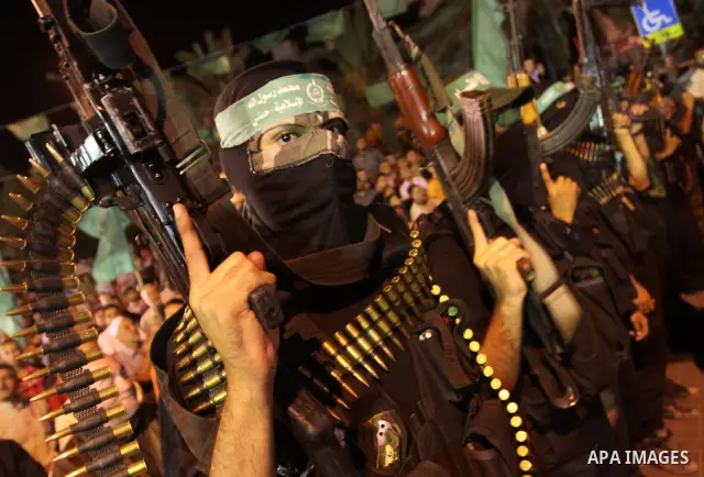 Palestinian militants of the Islamic group Hamas attend a celebration the release of hundreds of prisoners following a swap with captured Israeli soldier Gilad Shalit on October 21, 2011 in Gaza city. Hamas rulers are en...