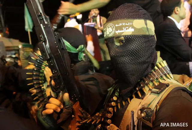 Palestinian militants of the Islamic group Hamas attend a celebration the release of hundreds of prisoners following a swap with captured Israeli soldier Gilad Shalit on October 21, 2011 in Gaza city. Hamas rulers are en...