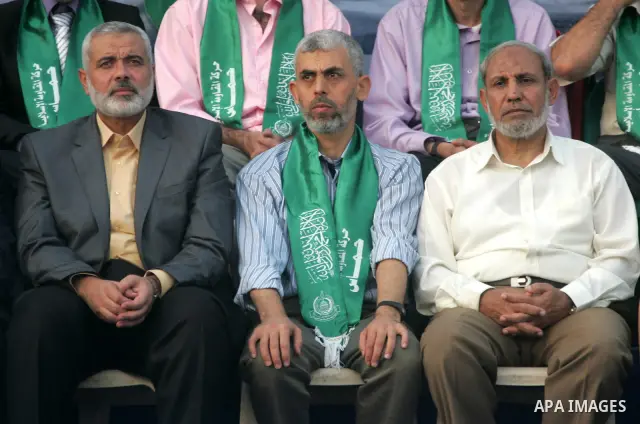 Freed Palestinian prisoner Yehiye Sinwar, a founder of Hamas' military wing, sits between Hamas leaders Ismail Haniya and Mahmoud al-Zahar as supporters celebrate the release of hundreds of prisoners following a swap wit...