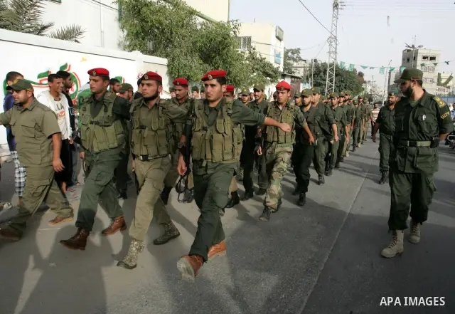 Palestinian Hamas security forces march as Hamas supporters celebrate the release of hundreds of prisoners following a swap with captured Israeli soldier Gilad Shalit on October 21, 2011 in Khan Yunis, southern Gaza Stri...