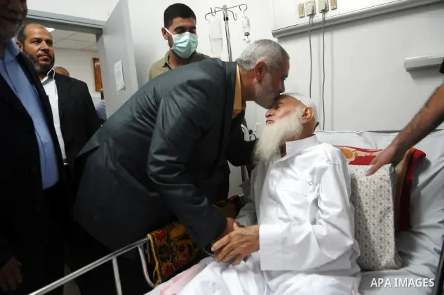 Palestinian Prime Minister in Gaza, Ismail Haniyeh during his visit to the father of the leader Abu Mohammed al-Najjar in the hospital to check on his health. Photo by Ahmed Shaat