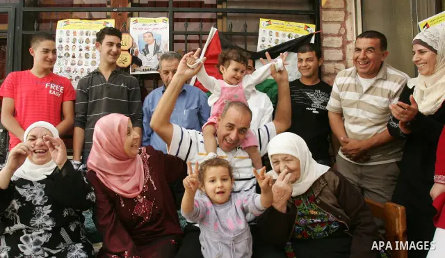 Freed Palestinian prisoner Nasser Abed Rabu is greeted by relatives and friends after her release from an Israeli jail in the East Jerusalem neighbourhood on October 22, 2011. The Palestinian Hamas movement exchanged Gil...
