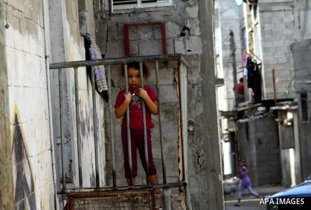 Palestinian refugee children play in front of their house at the Al-shatte' refugee camp in Gaza City on Oct. 23, 2011. Photo by Ashraf Amra