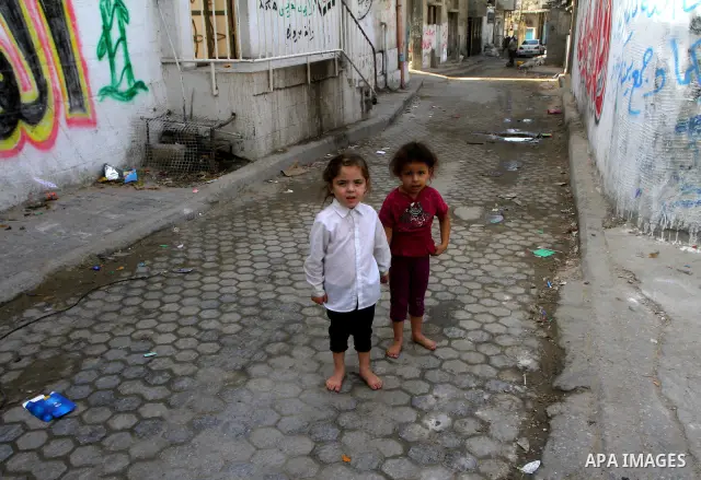 Palestinian refugee children play in front of their house at the Al-shatte' refugee camp in Gaza City on Oct. 23, 2011. Photo by Ashraf Amra
