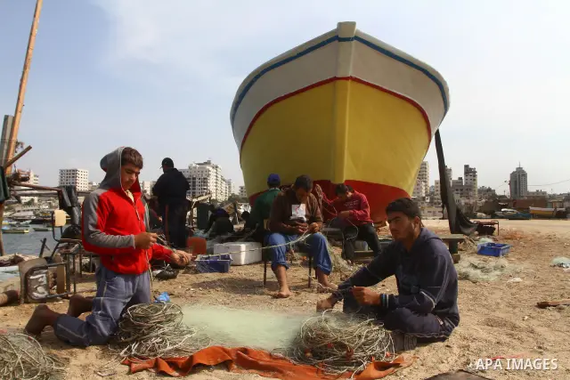 Palestinian fishermen work inside the port of Gaza City on Oct. 23, 2011. Fishermen, suffer from the tightening of the Israeli siege imposed on Palestinian fishermen a forbidden fishermen by Israel to enter the sea for m...