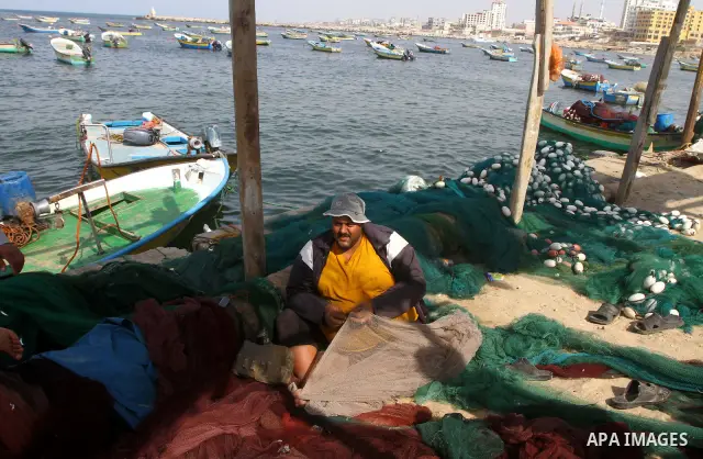 Palestinian fishermen work inside the port of Gaza City on Oct. 23, 2011. Fishermen, suffer from the tightening of the Israeli siege imposed on Palestinian fishermen a forbidden fishermen by Israel to enter the sea for m...