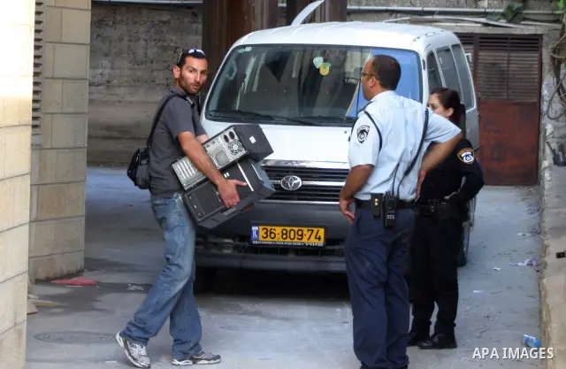 Israeli police officers stand guard during a raid on Al-Quds Development Association headquarters in Beit Hanina on Oct. 23,2011. Israeli forces stormed the association, destroyed some of its contents and confiscated com...
