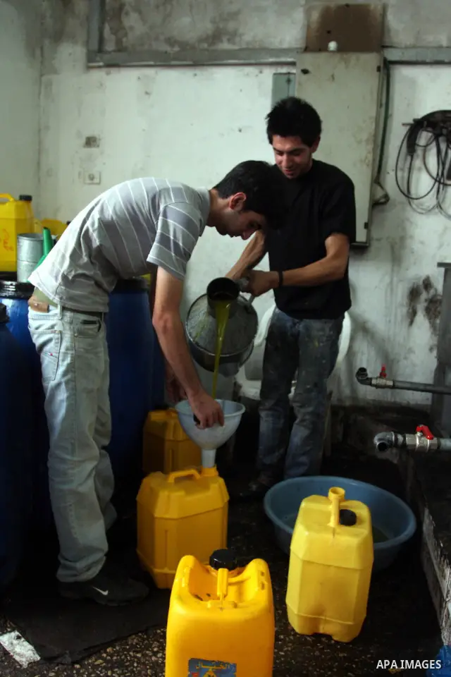 Palestinians producing olive oil in the olive oil factory in the West Bank village of Deir Bezia near the West Bank City of Ramallah on 23 October 2011 during the olive harvesting season. Agriculture is a major sector of...