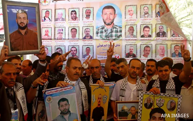 Palestinians gather during a protest at the Red Cross' offices in Gaza City to call for the release of Palestinian prisoners held in Israeli jails, on Oct. 24, 2011. Under a prisoner swap deal signed with Israel, the Isl...