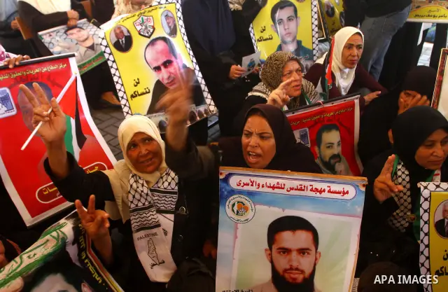 Palestinians gather during a protest at the Red Cross' offices in Gaza City to call for the release of Palestinian prisoners held in Israeli jails, on Oct. 24, 2011. Under a prisoner swap deal signed with Israel, the Isl...