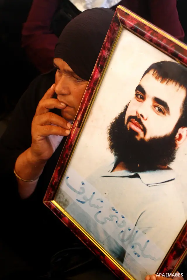Palestinians gather during a protest at the Red Cross' offices in Gaza City to call for the release of Palestinian prisoners held in Israeli jails, on Oct. 24, 2011. Under a prisoner swap deal signed with Israel, the Isl...
