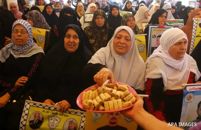 Palestinians gather during a protest at the Red Cross' offices in Gaza City to call for the release of Palestinian prisoners held in Israeli jails, on Oct. 24, 2011. Under a prisoner swap deal signed with Israel, the Isl...