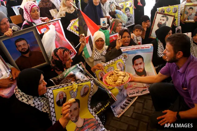 Palestinians gather during a protest at the Red Cross' offices in Gaza City to call for the release of Palestinian prisoners held in Israeli jails, on Oct. 24, 2011. Under a prisoner swap deal signed with Israel, the Isl...