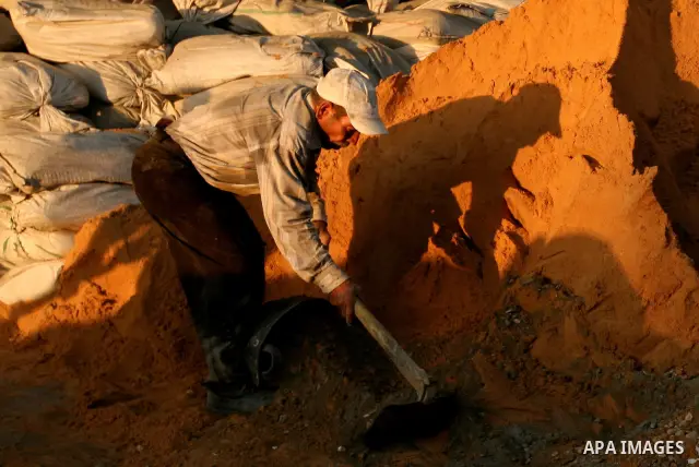 Palestinian labourers work in a residential construction site in Gaza city on Oct. 24,2011 as Palestinians in Gaza Strip suffer from lack of construction materials since the Israeli blockade so they use the tunnels under...