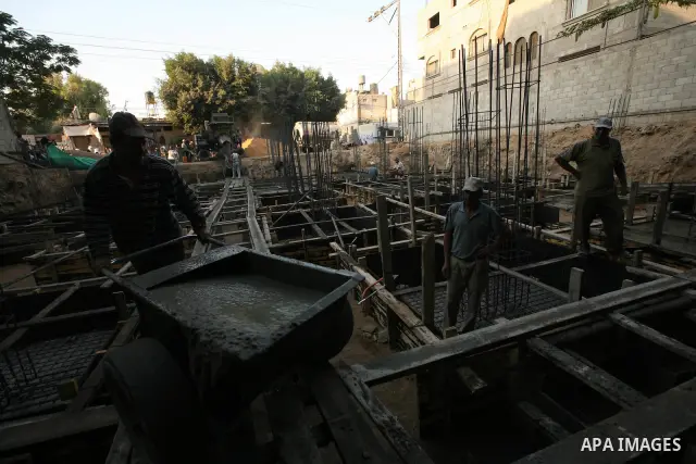 Palestinian labourers work in a residential construction site in Gaza city on Oct. 24,2011 as Palestinians in Gaza Strip suffer from lack of construction materials since the Israeli blockade so they use the tunnels under...