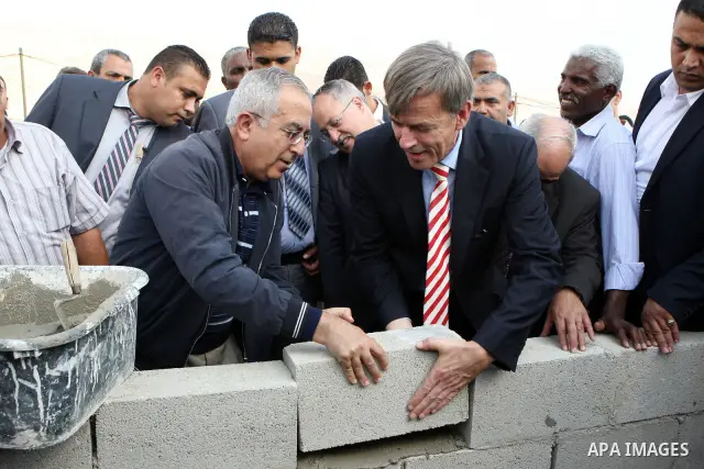 Palestinian Prime Minister Salam Fayyad and the German representative, Jayutz Lengenthal place the foundation stone for the health center in the West Bank city of Jericho on Oct. 26,2011. Photo by Mustafa Abu Dayeh