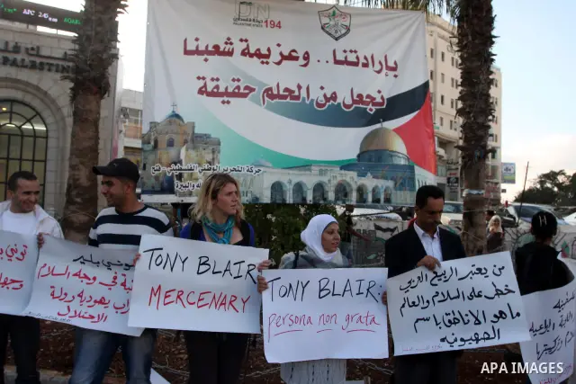Palestinians hold placards against the policy of the Quartet envoy in the Middle East Tony Blair during a protest in the West Bank city of Ramallah. On October 26, 2011. Palestinian protesters demanded the departure of T...