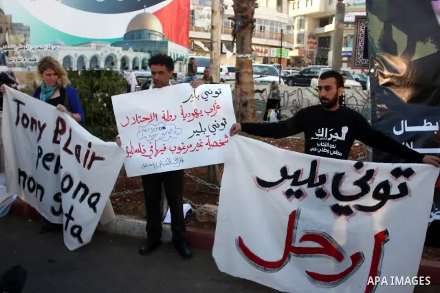 Palestinians hold placards against the policy of the Quartet envoy in the Middle East Tony Blair during a protest in the West Bank city of Ramallah. On October 26, 2011. Palestinian protesters demanded the departure of T...