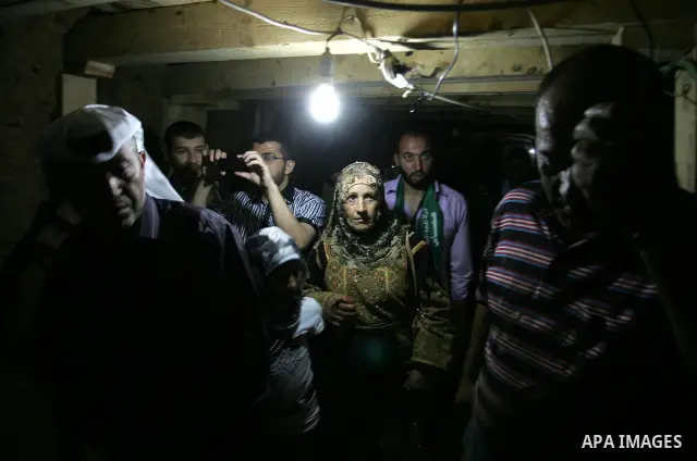 Freed Palestinian prisoners and their relatives walk through a tunnel underground the border between Egypt and southern Gaza Strip town of Rafah on Oct. 26,2011. Prisoners released to the Gaza Strip in a dramatic swap fo...