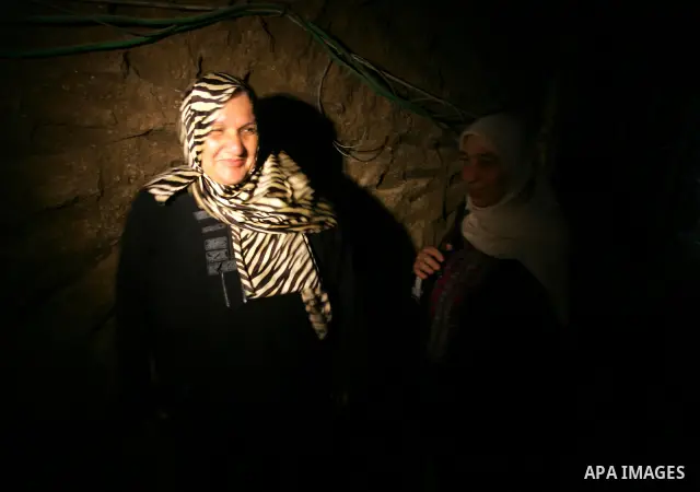 Freed Palestinian prisoners and their relatives walk through a tunnel underground the border between Egypt and southern Gaza Strip town of Rafah on Oct. 26,2011. Prisoners released to the Gaza Strip in a dramatic swap fo...