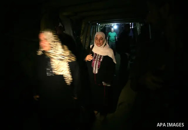 Freed Palestinian prisoners and their relatives walk through a tunnel underground the border between Egypt and southern Gaza Strip town of Rafah on Oct. 26,2011. Prisoners released to the Gaza Strip in a dramatic swap fo...