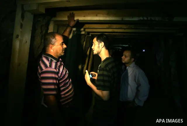 Freed Palestinian prisoners and their relatives walk through a tunnel underground the border between Egypt and southern Gaza Strip town of Rafah on Oct. 26,2011. Prisoners released to the Gaza Strip in a dramatic swap fo...